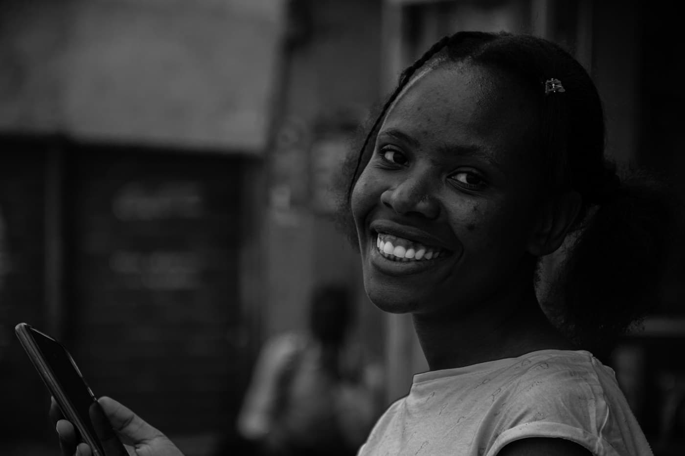 A woman smiling with her phone in hand